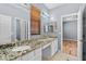 Bathroom featuring double sinks, granite countertop, and wood-slat blinds at 10281 Wolves Den Ln, Las Vegas, NV 89178