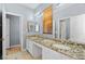 Stylish bathroom with double sinks, granite countertops, and dual mirrors at 10281 Wolves Den Ln, Las Vegas, NV 89178