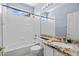 Clean bathroom with tub, granite vanity, and updated fixtures at 10281 Wolves Den Ln, Las Vegas, NV 89178