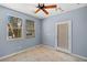 Bedroom with tile floors, ceiling fan, and bright natural light at 10281 Wolves Den Ln, Las Vegas, NV 89178