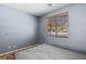 Bedroom featuring wood floors, a window overlooking the yard, and neutral wall color at 10281 Wolves Den Ln, Las Vegas, NV 89178