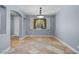 Light-filled dining room with stylish light fixture and beautiful window at 10281 Wolves Den Ln, Las Vegas, NV 89178