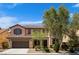 Charming two-story home featuring a two-car garage and low maintenance landscaping at 10281 Wolves Den Ln, Las Vegas, NV 89178