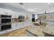 Spacious kitchen featuring stainless steel appliances, granite countertops, and white cabinetry at 10281 Wolves Den Ln, Las Vegas, NV 89178
