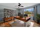 Well-lit office with modern desk, shelving, and views of the landscaped yard at 10281 Wolves Den Ln, Las Vegas, NV 89178
