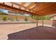 Covered patio with stamped concrete, retaining wall, and professional landscaping at 10281 Wolves Den Ln, Las Vegas, NV 89178