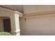 Beige two-story home featuring a covered entrance and desert landscaping at 10282 Keystone Pastures St, Las Vegas, NV 89183