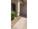 Beige two-story home featuring a covered entrance and desert landscaping at 10282 Keystone Pastures St, Las Vegas, NV 89183