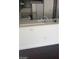 This kitchen has a breakfast bar with a sink and stainless steel refrigerator at 10282 Keystone Pastures St, Las Vegas, NV 89183