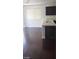 Kitchen area with dark laminate flooring and natural light from the large window at 10282 Keystone Pastures St, Las Vegas, NV 89183