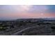 An aerial view showcases city lights and surrounding landscape with mountain views at 10309 Canyon Valley Ave, Las Vegas, NV 89145