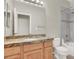 Well-lit bathroom features granite counters, modern fixtures, and a shower over tub at 10309 Canyon Valley Ave, Las Vegas, NV 89145