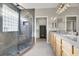 Primary bathroom features a double vanity, stone shower with bench, and a walk-in closet at 10309 Canyon Valley Ave, Las Vegas, NV 89145