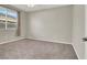 Bedroom boasts carpet, large window with blinds, and neutral walls at 10309 Canyon Valley Ave, Las Vegas, NV 89145