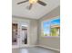 Bright bedroom features a ceiling fan, double doors to the outside, and a window at 10309 Canyon Valley Ave, Las Vegas, NV 89145