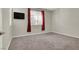Bedroom featuring neutral carpeting, white blinds and red curtains, and ceiling-mounted television at 10309 Canyon Valley Ave, Las Vegas, NV 89145