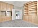Bright, carpeted bedroom with custom built in shelving units; natural light floods the room at 10309 Canyon Valley Ave, Las Vegas, NV 89145