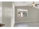 Bright bedroom features a ceiling fan, ample natural light from a large window, and neutral walls at 10309 Canyon Valley Ave, Las Vegas, NV 89145