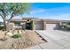 Beautiful single-story home with stone accents, well-manicured landscaping, and an attached two-car garage at 10309 Canyon Valley Ave, Las Vegas, NV 89145