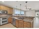 Open concept kitchen with granite countertops, stainless appliances and pendant lighting at 10309 Canyon Valley Ave, Las Vegas, NV 89145