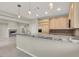 Bright kitchen boasts granite counters, stylish pendant lighting, and stainless steel appliances at 10309 Canyon Valley Ave, Las Vegas, NV 89145