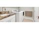Laundry room with front loading washer and dryer, folding table, and granite countertop at 10309 Canyon Valley Ave, Las Vegas, NV 89145