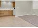 Living area with tile and carpeted flooring, adjacent to kitchenette at 10309 Canyon Valley Ave, Las Vegas, NV 89145