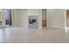 Spacious living room featuring tile floors, a modern fireplace, and an adjacent doorway at 10309 Canyon Valley Ave, Las Vegas, NV 89145