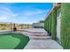 Inviting outdoor patio with a multi-tiered design, lush greenery, and a charming chiminea at 10309 Canyon Valley Ave, Las Vegas, NV 89145
