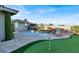 Gorgeous backyard with a pool, waterfall feature, putting green and manicured landscaping at 10309 Canyon Valley Ave, Las Vegas, NV 89145