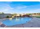Beautiful in-ground pool with waterfall feature, palm trees, and ample patio space at 10309 Canyon Valley Ave, Las Vegas, NV 89145