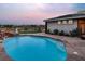 Stunning backyard featuring a pool with a waterfall, putting green, and well-manicured landscaping at 10309 Canyon Valley Ave, Las Vegas, NV 89145