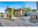 Exterior view of the house with lush landscaping, a built-in barbeque, and natural stone pavers at 10309 Canyon Valley Ave, Las Vegas, NV 89145