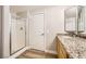 Bathroom featuring granite countertops, a glass-enclosed shower, and vinyl flooring at 10550 W Alexander Rd # 2179, Las Vegas, NV 89129