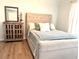 Bright bedroom featuring a decorative cabinet, mirror, and neutral-toned furniture at 10550 W Alexander Rd # 2179, Las Vegas, NV 89129