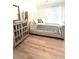 Charming bedroom features a luxurious upholstered bed and stylish wood-look flooring at 10550 W Alexander Rd # 2179, Las Vegas, NV 89129
