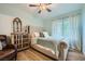 Bedroom with a decorative cabinet, a comfortable-looking bed, and bright natural lighting at 10550 W Alexander Rd # 2179, Las Vegas, NV 89129