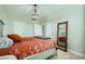 Bedroom with stylish chandelier, plush carpet, full-length mirror and modern color scheme at 10550 W Alexander Rd # 2179, Las Vegas, NV 89129