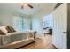 Bedroom with stylish decor, a ceiling fan, and a view into the light and airy living room at 10550 W Alexander Rd # 2179, Las Vegas, NV 89129