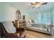 Bedroom featuring a leather chair and a bed with lots of natural light coming from the window at 10550 W Alexander Rd # 2179, Las Vegas, NV 89129
