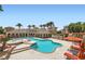 Resort-style community pool with lounge chairs and meticulously kept landscaping at 10550 W Alexander Rd # 2179, Las Vegas, NV 89129