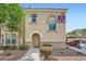 Apartment exterior shows stucco facade, arched entry, and manicured landscaping at 10550 W Alexander Rd # 2179, Las Vegas, NV 89129