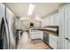 A kitchen that opens to the living room, stainless steel appliances, and bright lighting at 10550 W Alexander Rd # 2179, Las Vegas, NV 89129