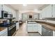 A kitchen with stainless steel appliances and an open view to the living room at 10550 W Alexander Rd # 2179, Las Vegas, NV 89129
