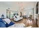 Bright living room featuring wood floors, fireplace, a chandelier, and open access to the kitchen at 10550 W Alexander Rd # 2179, Las Vegas, NV 89129