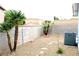 A private backyard space features desert landscaping, a block wall and HVAC unit at 128 Golf Course St, Las Vegas, NV 89145