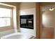 Inviting bathroom featuring a soaking tub and a fireplace, providing a cozy and relaxing ambiance at 128 Golf Course St, Las Vegas, NV 89145