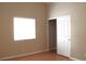 Bright bedroom with closet, wood floors, and natural light streaming through the window at 128 Golf Course St, Las Vegas, NV 89145