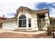 Charming single-story home with desert landscaping, two-car garage, and large arched window at 128 Golf Course St, Las Vegas, NV 89145
