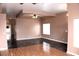 Spacious living room with hardwood floors, a ceiling fan, and a large window at 128 Golf Course St, Las Vegas, NV 89145